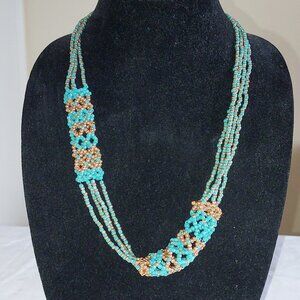 24" Necklace of netted copper and aqua colored seed beads with a toggle clasp